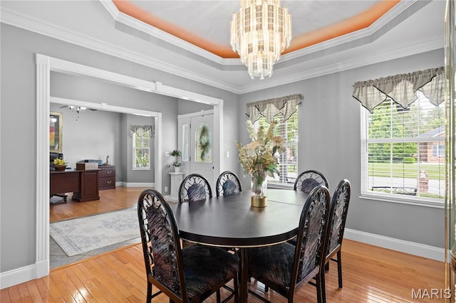 1171 Red Hawk Ridge Ln, Ofallon, IL 62269 - dining space with a chandelier, plenty of natural light, light wood-style floors, a raised ceiling, and crown molding