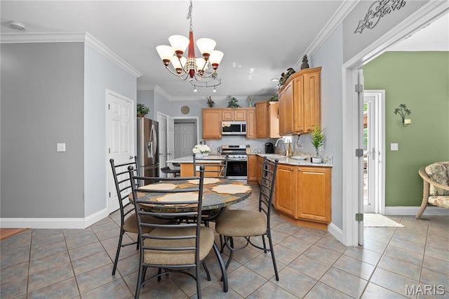 1171 Red Hawk Ridge Ln, Ofallon, IL 62269 - kitchen featuring appliances with stainless steel finishes, light tile patterned floors, a chandelier, crown molding, and baseboards