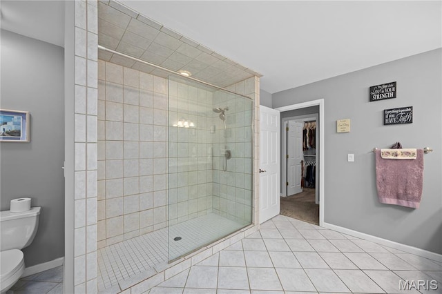 1171 Red Hawk Ridge Ln, Ofallon, IL 62269 - bathroom with toilet, a stall shower, tile patterned flooring, baseboards, and a walk in closet