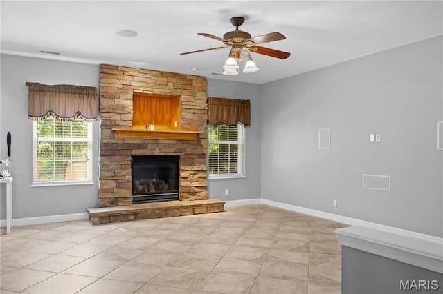 1171 Red Hawk Ridge Ln, Ofallon, IL 62269 - unfurnished living room featuring a fireplace, baseboards, a ceiling fan, and light tile patterned flooring