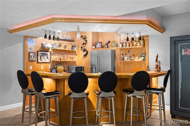 1171 Red Hawk Ridge Ln, Ofallon, IL 62269 - indoor bar featuring stainless steel appliances, rail lighting, tile patterned floors, and baseboards