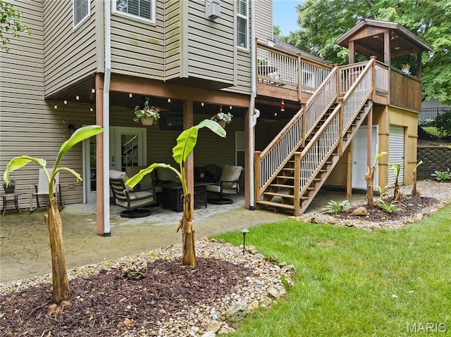 1171 Red Hawk Ridge Ln, Ofallon, IL 62269 - rear view of house with a wooden deck, a patio area, an outdoor living space, and stairs