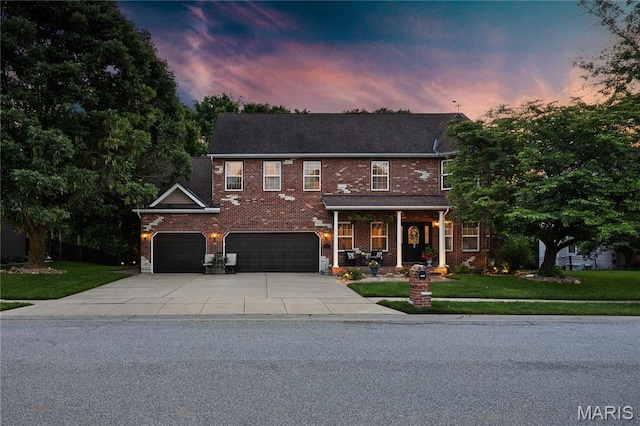 1171 Red Hawk Ridge Ln, Ofallon, IL 62269 - view of front of house with a yard, concrete driveway, covered porch, and brick siding