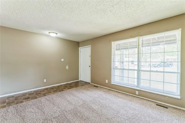 6250 Pennyrich Ct, Florissant, MO 63033 - carpeted empty room featuring a textured ceiling and baseboards