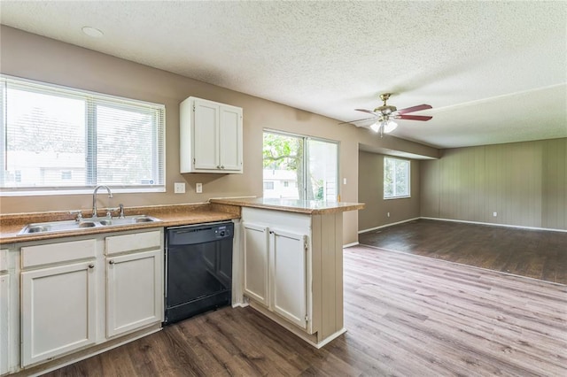 6250 Pennyrich Ct, Florissant, MO 63033 - kitchen featuring dishwasher, a sink, dark wood finished floors, a peninsula, and open floor plan