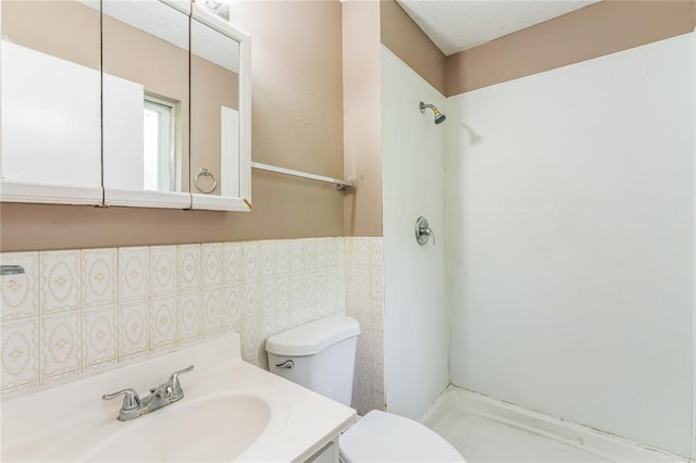 6250 Pennyrich Ct, Florissant, MO 63033 - bathroom featuring toilet, a shower, vanity, and tile walls