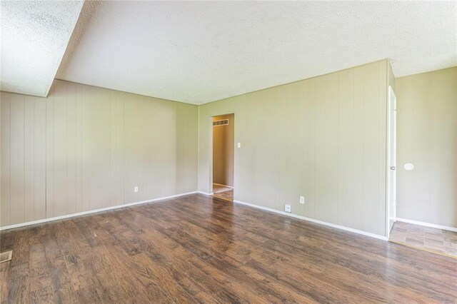 6250 Pennyrich Ct, Florissant, MO 63033 - empty room featuring wood finished floors, baseboards, and a textured ceiling