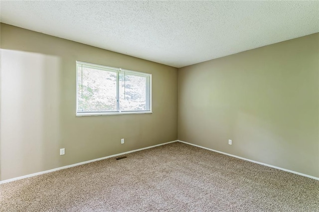 6250 Pennyrich Ct, Florissant, MO 63033 - spare room with carpet floors, baseboards, and a textured ceiling
