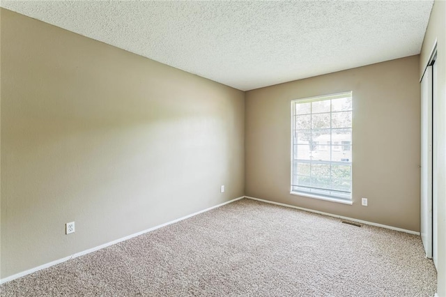 6250 Pennyrich Ct, Florissant, MO 63033 - carpeted spare room with a textured ceiling and baseboards