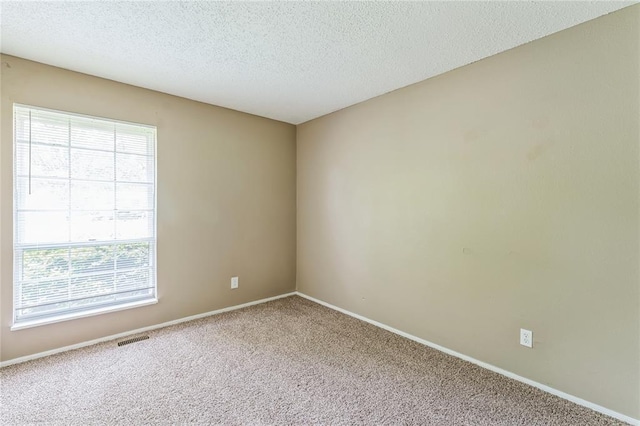 6250 Pennyrich Ct, Florissant, MO 63033 - carpeted spare room with baseboards and a textured ceiling