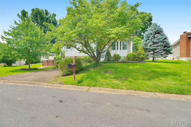 2631 Georgia Dr, Arnold, MO 63010 - view of property hidden behind natural elements with a front yard and asphalt driveway