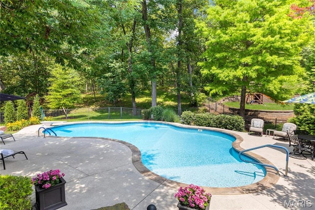 4388 Austin Pass Dr, Saint Charles, MO 63304 - view of swimming pool featuring a patio, a diving board, and view of wooded area