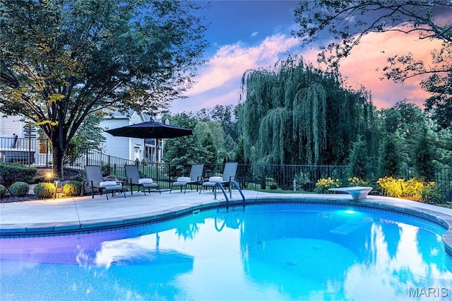 4388 Austin Pass Dr, Saint Charles, MO 63304 - pool at dusk with a patio area and a diving board