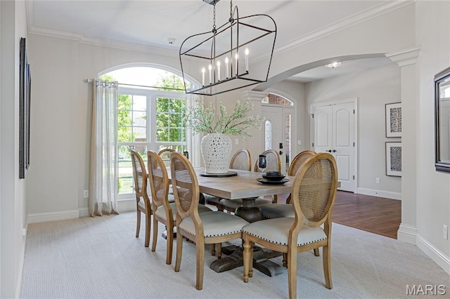 4388 Austin Pass Dr, Saint Charles, MO 63304 - dining space with arched walkways, carpet flooring, ornamental molding, and a chandelier
