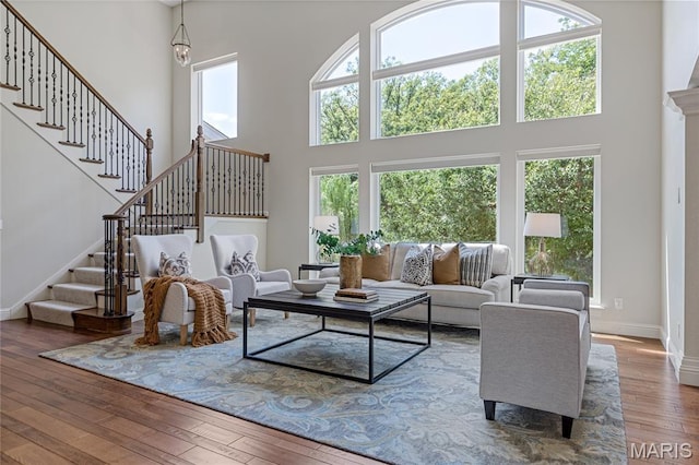 4388 Austin Pass Dr, Saint Charles, MO 63304 - living area with a towering ceiling, stairs, and hardwood / wood-style flooring