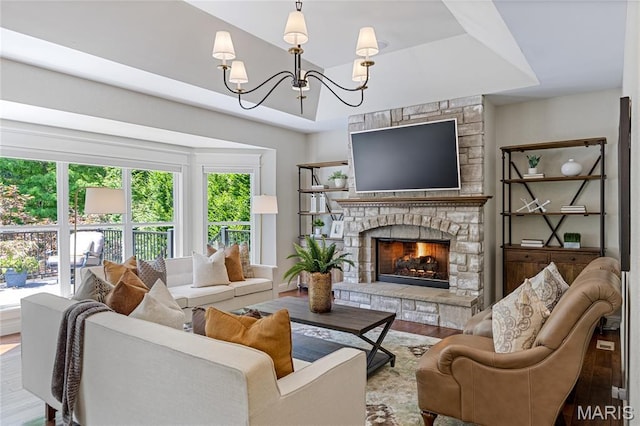 4388 Austin Pass Dr, Saint Charles, MO 63304 - living room with plenty of natural light, wood finished floors, a chandelier, and a stone fireplace