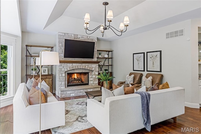 4388 Austin Pass Dr, Saint Charles, MO 63304 - living area featuring a raised ceiling, wood finished floors, a chandelier, and a stone fireplace