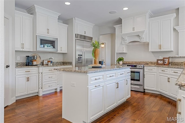 4388 Austin Pass Dr, Saint Charles, MO 63304 - kitchen with built in appliances, dark wood finished floors, recessed lighting, and white cabinets