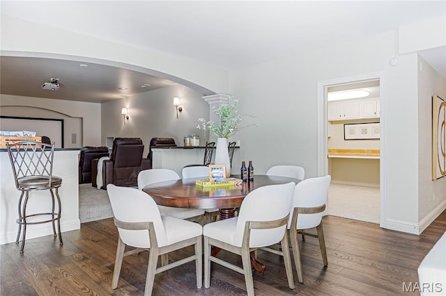 4388 Austin Pass Dr, Saint Charles, MO 63304 - dining space featuring arched walkways and dark wood-style floors