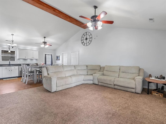109 N 7th St, Owensville, MO 65066 - carpeted living room featuring ceiling fan, beamed ceiling, a sink, high vaulted ceiling, and a chandelier