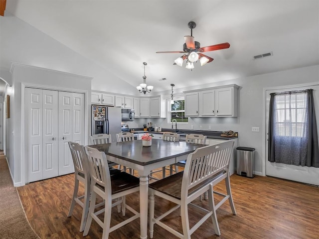 109 N 7th St, Owensville, MO 65066 - dining area with vaulted ceiling, a ceiling fan, dark wood-style flooring, a chandelier, and baseboards