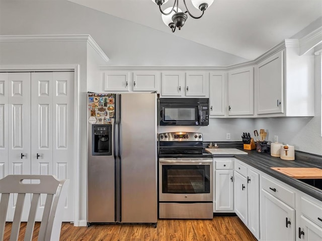 109 N 7th St, Owensville, MO 65066 - kitchen featuring stainless steel appliances, lofted ceiling, a chandelier, white cabinets, and dark countertops