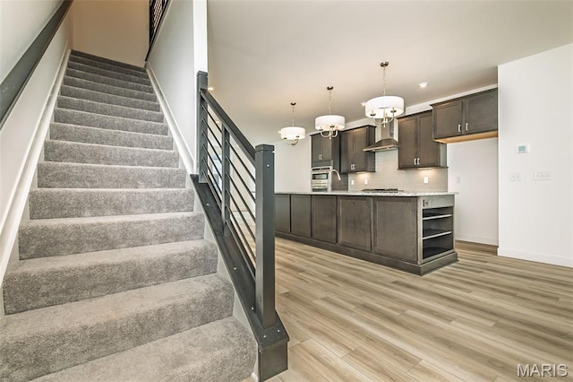 8916 Gateway Cir Unit 41-805, Richmond Heights, MO 63144 - stairway featuring wood finished floors, a chandelier, and recessed lighting