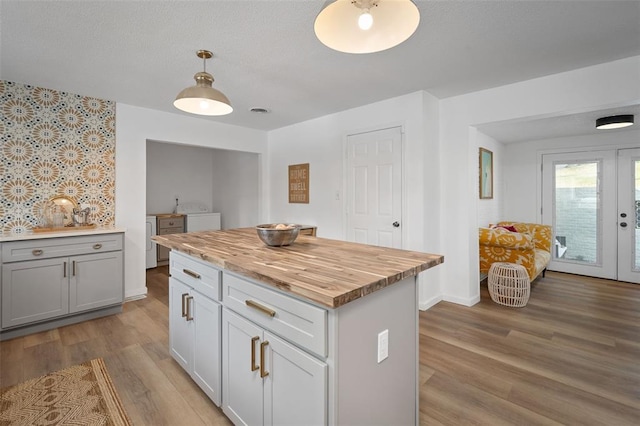 1594 Rue Calais, Bonne Terre, MO 63628 - kitchen with washing machine and dryer, butcher block countertops, wood finished floors, and french doors