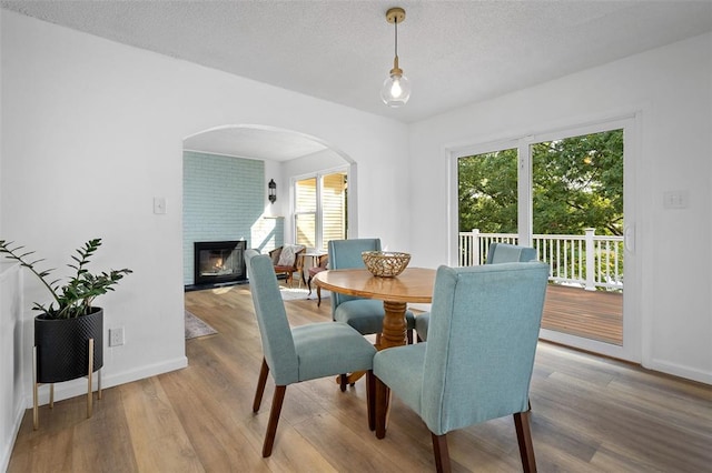 1594 Rue Calais, Bonne Terre, MO 63628 - dining room with wood finished floors, arched walkways, healthy amount of natural light, baseboards, and a textured ceiling
