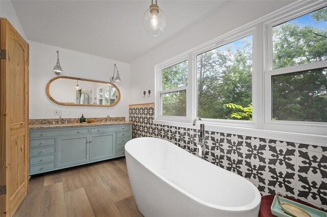 1594 Rue Calais, Bonne Terre, MO 63628 - full bathroom with a freestanding tub, vanity, wood finished floors, and wainscoting