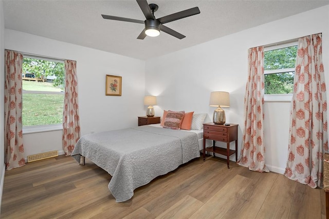 1594 Rue Calais, Bonne Terre, MO 63628 - bedroom featuring wood finished floors, multiple windows, and ceiling fan