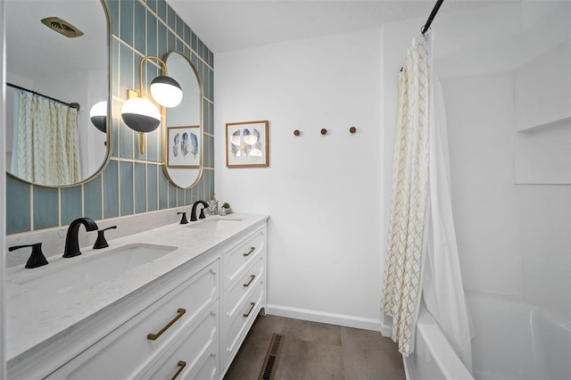 1594 Rue Calais, Bonne Terre, MO 63628 - bathroom with double vanity, shower / tub combo with curtain, wood finished floors, and baseboards