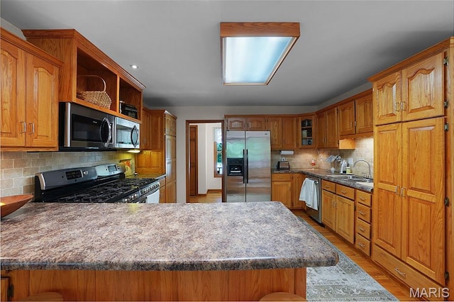 238 Skyway Dr, New Haven, MO 63068 - kitchen with appliances with stainless steel finishes, tasteful backsplash, brown cabinetry, a peninsula, and open shelves