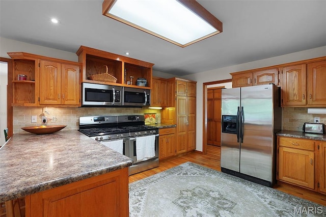 238 Skyway Dr, New Haven, MO 63068 - kitchen featuring open shelves, stainless steel appliances, tasteful backsplash, light wood-type flooring, and brown cabinetry
