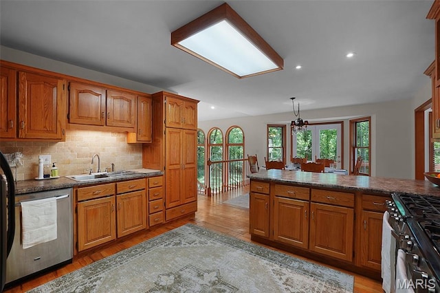 238 Skyway Dr, New Haven, MO 63068 - kitchen featuring stainless steel appliances, brown cabinets, dark countertops, and recessed lighting