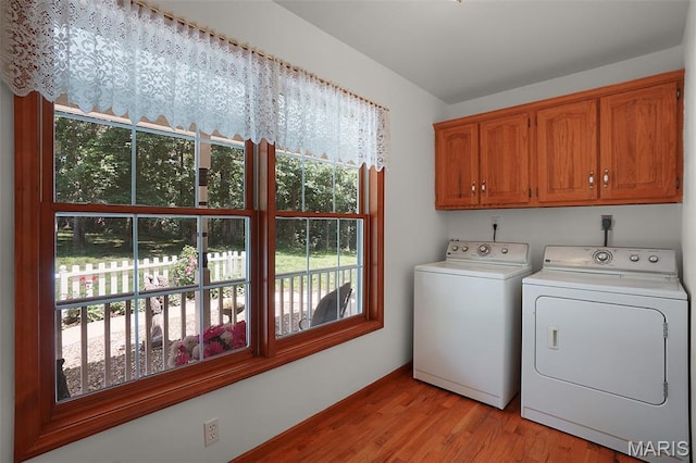 238 Skyway Dr, New Haven, MO 63068 - laundry area featuring independent washer and dryer, cabinet space, and healthy amount of natural light