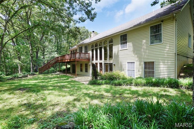 238 Skyway Dr, New Haven, MO 63068 - back of house with stairway, a wooden deck, a chimney, and a lawn