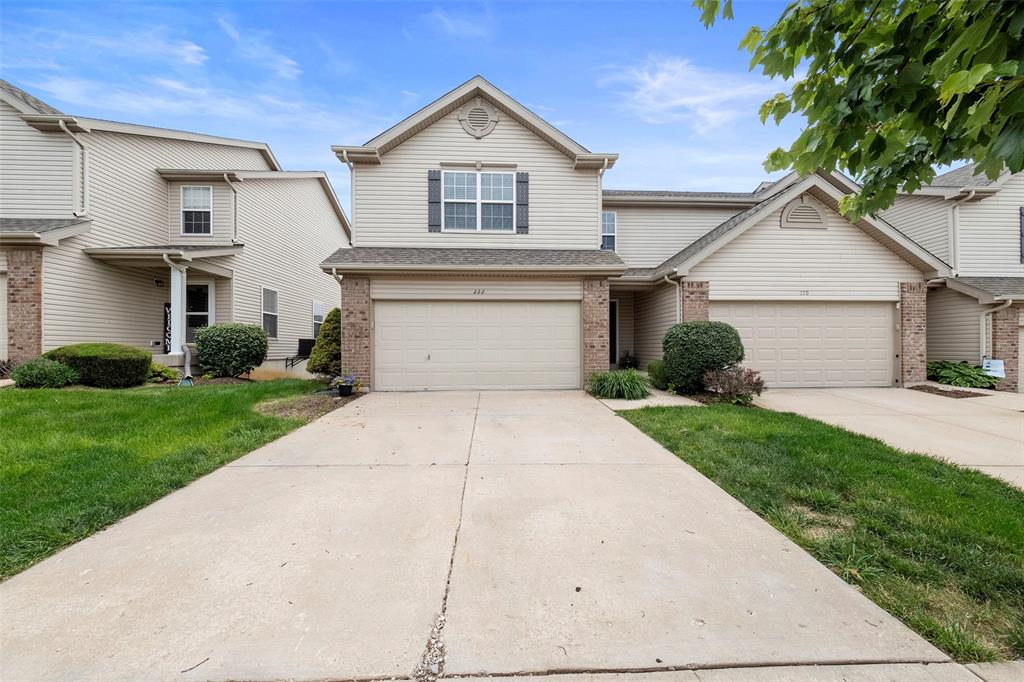 222 Shady Rock Ln, Ofallon, MO 63368 - view of front of property featuring brick siding, concrete driveway, a front lawn, and a garage