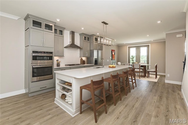 8919 E Gateway Hts Unit 94-804, Richmond Heights, MO 63144 - kitchen featuring wall chimney range hood, gray cabinetry, open shelves, crown molding, and light countertops