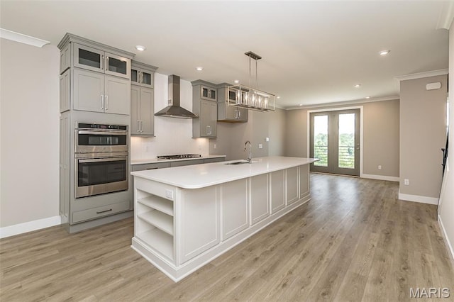 8919 E Gateway Hts Unit 94-804, Richmond Heights, MO 63144 - kitchen featuring wall chimney exhaust hood, open shelves, gray cabinetry, a sink, and an island with sink