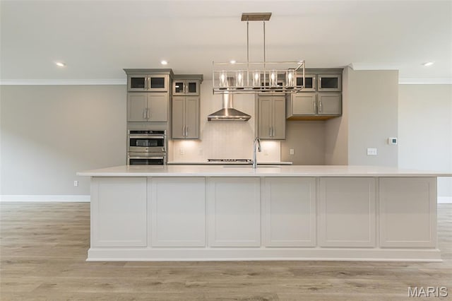 8919 E Gateway Hts Unit 94-804, Richmond Heights, MO 63144 - kitchen with wall chimney range hood, gray cabinetry, double oven, a sink, and crown molding