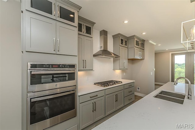 8919 E Gateway Hts Unit 94-804, Richmond Heights, MO 63144 - kitchen with wall chimney range hood, a sink, stainless steel appliances, gray cabinetry, and recessed lighting