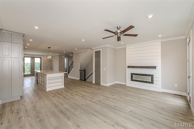 8919 E Gateway Hts Unit 94-804, Richmond Heights, MO 63144 - unfurnished living room with crown molding, a sink, recessed lighting, baseboards, and light wood finished floors