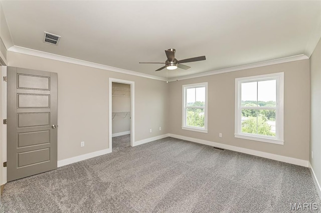 8919 E Gateway Hts Unit 94-804, Richmond Heights, MO 63144 - unfurnished bedroom featuring baseboards, crown molding, carpet, a spacious closet, and a ceiling fan