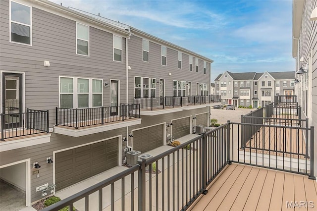 8919 E Gateway Hts Unit 94-804, Richmond Heights, MO 63144 - wooden deck with a residential view, central AC unit, and an attached garage