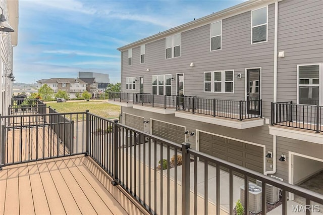 8919 E Gateway Hts Unit 94-804, Richmond Heights, MO 63144 - wooden terrace featuring central air condition unit and a garage