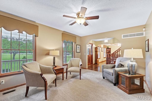 22 Fox Valley Ct, Lake St Louis, MO 63367 - living area featuring carpet, a ceiling fan, baseboards, stairway, and a textured ceiling