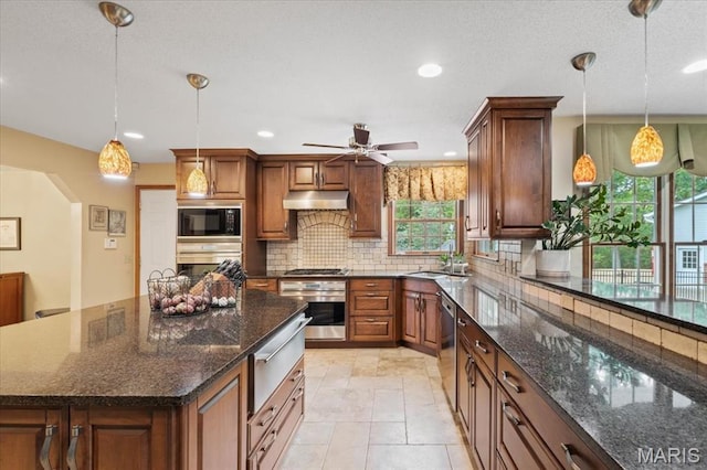 22 Fox Valley Ct, Lake St Louis, MO 63367 - kitchen with stainless steel appliances, a warming drawer, a sink, decorative backsplash, and ceiling fan