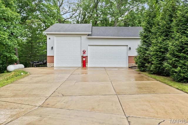 22 Fox Valley Ct, Lake St Louis, MO 63367 - garage with concrete driveway and view of wooded area
