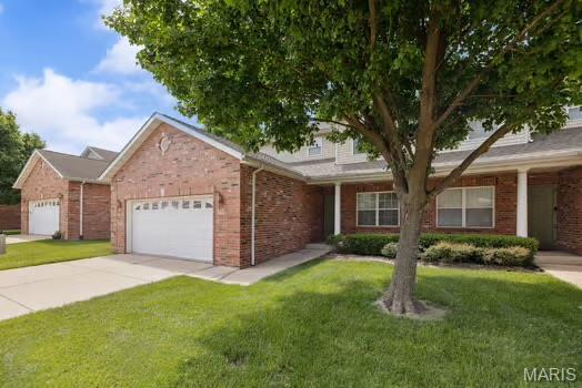 754 Michael St, Ofallon, IL 62269 - view of front of property with a garage, a front lawn, driveway, and brick siding